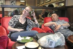 Lea next to a sleeping guy at the coffee place